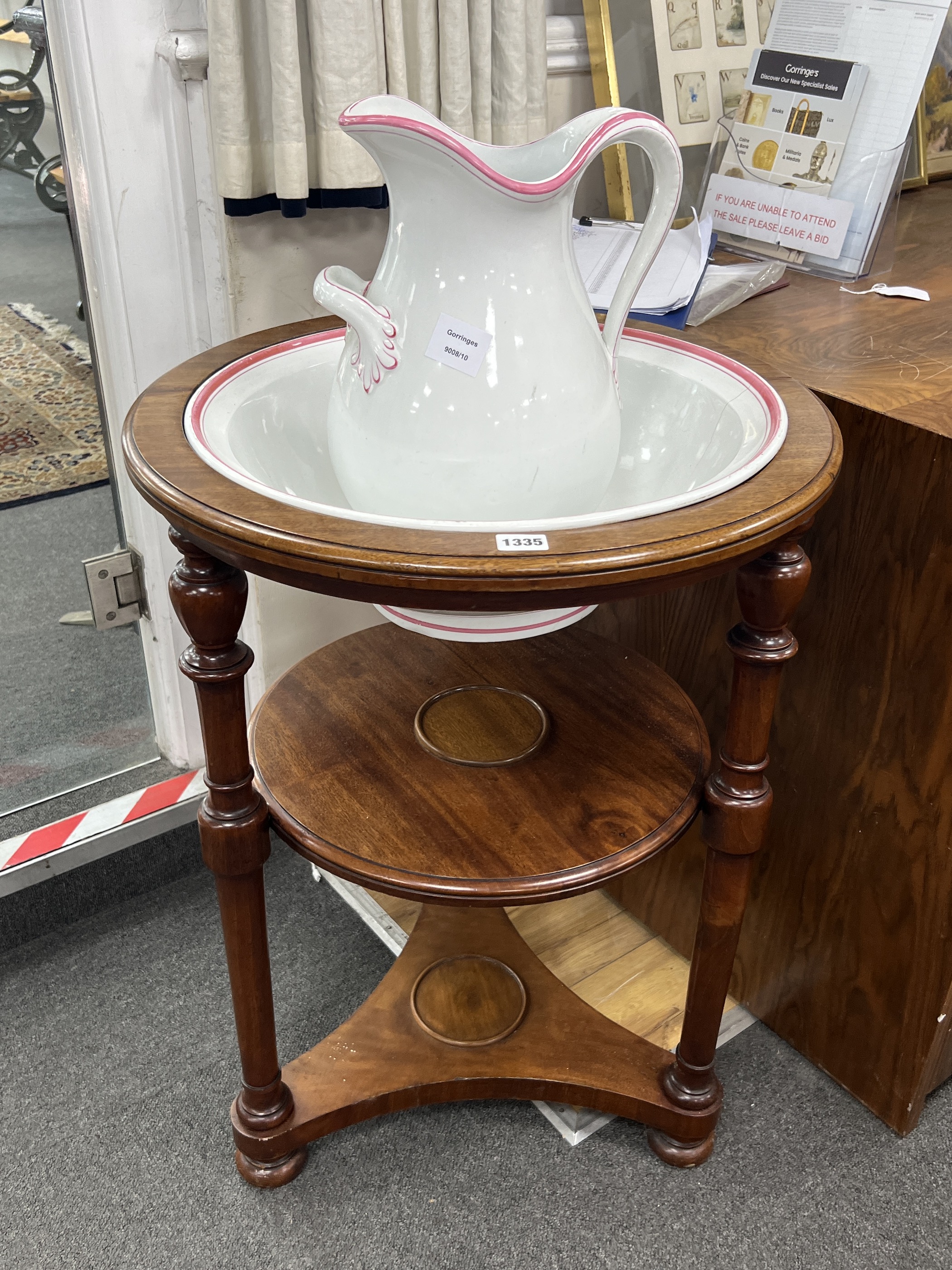 A Victorian circular mahogany three tier washstand with ceramic jug and basin, diameter 55cm, height 76cm